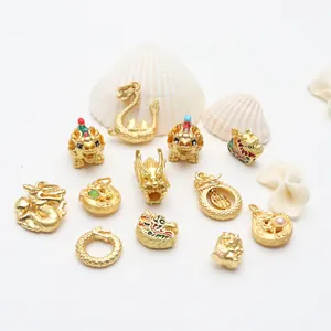 Macro view of ancient gold dragon charms and enamel jewelry pendants on white seashells
