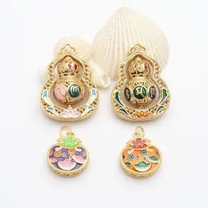 Detailed view of rotating gold gourd and lucky bag pendants with colorful enamel
