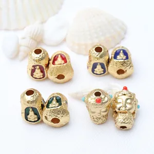 Close-up detail of Thai Buddha gold beads with colorful enamel dripping for DIY jewelry crafts