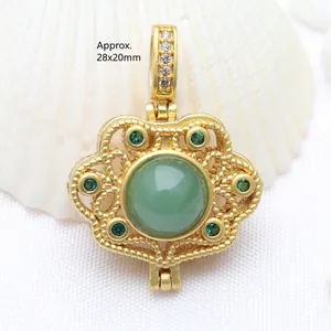Detail view of vintage gold filigree Ruyi lock pendant with a large green gemstone
