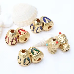 Macro detail of Thai Buddha gold beads with colorful enamel inlay for jewelry DIY