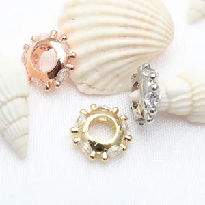 Macro detail of micro-pave zircon spacer beads in gold, silver, and rose gold finishes