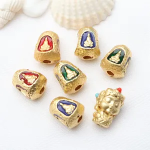 Detailed macro view of Thai style Buddha gold charms with colorful enamel for DIY jewelry making
