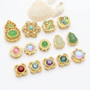 Macro detail of various gold plated jewelry spacer beads with colorful stones and pearls