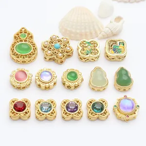 Macro view of various gold-plated jewelry spacer beads with colorful stones and pearls.