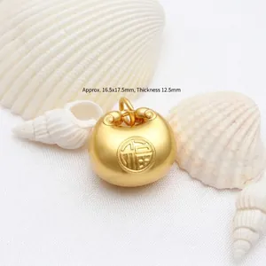 Macro view of antique gold Fu pendant with dimensions 16.5x17.5mm on shells.