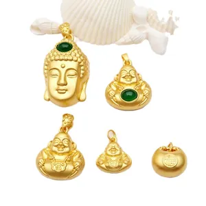 Close-up of gold-plated Buddha and Fu pendants with green inlay details.