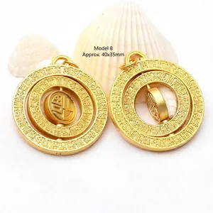 Detail view of rotating gold Fu pendant measuring 40x35mm with intricate engraving.