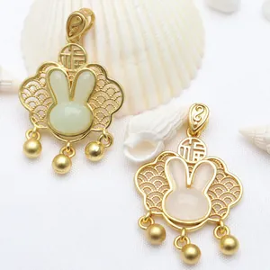 Close-up of golden Ruyi lock pendants with cute rabbit jade-like inlays