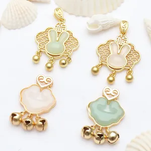 Detail of gold-sand Ruyi lock pendants with jade-like bunny and bell charms