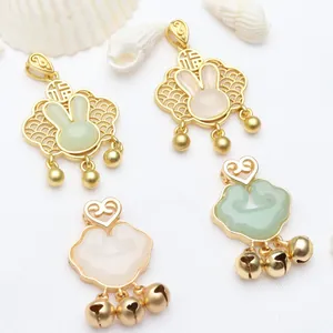 Detailed view of gold rabbit and ruyi lock pendants for DIY jewelry
