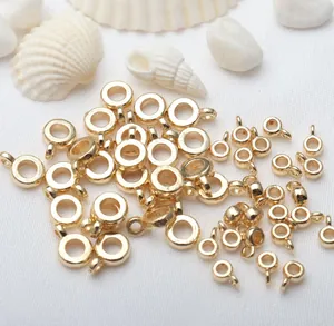 Macro detail of 18K gold-plated circular pendant rings for DIY jewelry making findings