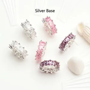 Detailed macro view of zircon wheel spacer beads with silver base in assorted colors