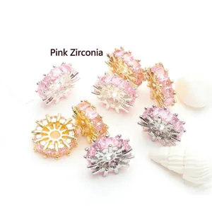 Detailed view of pink cubic zirconia wheel-shaped spacer beads for jewelry making