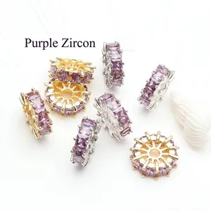 Detailed view of purple cubic zirconia wheel spacer beads in gold and silver plating