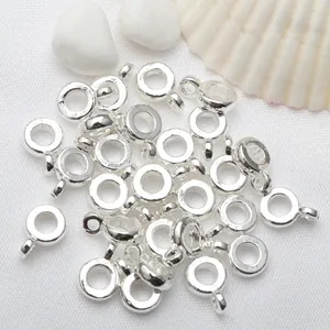 Detailed macro view of shiny silver circular pendant loops for DIY jewelry making