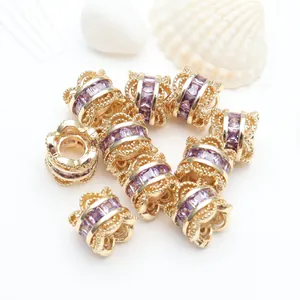 Detailed macro view of 14K gold-plated spacer beads with purple micro-set zirconia stones