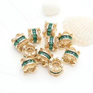 Macro view of 14K gold plated spacer beads with green zircons for DIY jewelry design