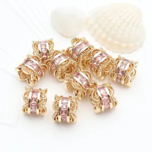 Detailed close-up of 14K gold-plated barrel beads with micro-set pink zircon stones