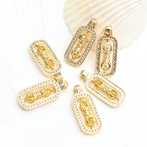 Detail view of 18K gold plated rotating Vajra pestle pendants with micro-pave zircons