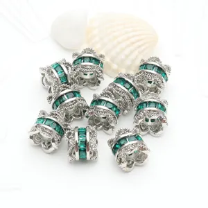 Silver spacer beads with green cubic zirconia and double-sided flower cap design