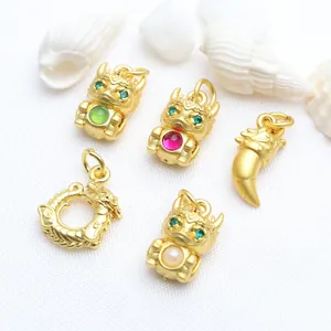 Detailed close-up of ancient sand gold dragon charms with inlaid colorful gemstones for DIY.