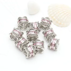 Close-up detail of micro-paved pink zircon small waist spacer beads for DIY bracelets