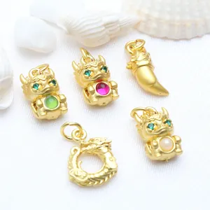 Detailed view of gold dragon zodiac charms with colorful stone inlays