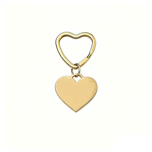 Polished gold stainless steel heart-shaped keychain with matching heart ring pendant.