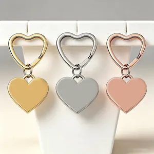 Three colors of heart-shaped stainless steel keychains shown on a white display stand