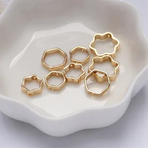 Close-up of 14K gold filled hexagon and flower jewelry spacer beads in a white bowl