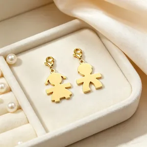 Detailaufnahme von goldenen Jungen und Mädchen Charms in einer Schmuckschatulle aus Stahl