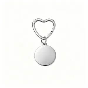 Detailed view of polished stainless steel circular tag and heart-shaped keychain ring