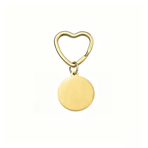 Detailed view of a golden stainless steel heart-shaped keychain with a blank round tag