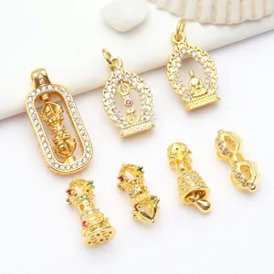 Detailed view of ancient gold Vajra and Buddha pendants for DIY jewelry