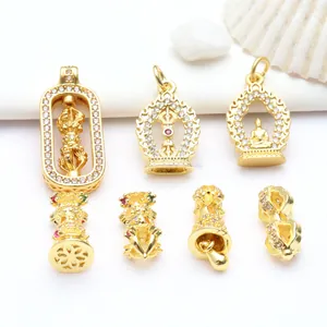 Detailed view of gold Buddhist jewelry pendants and beads with sparkling zircon inlays