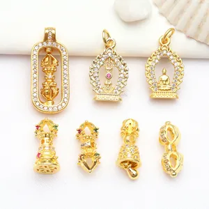 Close-up of gold-plated Buddhist charms with inlaid cubic zirconia for jewelry making