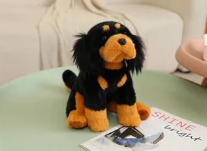 Close-up of a realistic black and tan plush dog toy on a mint green table