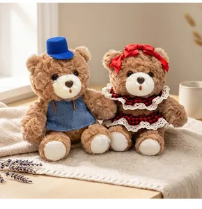 Pair of cute brown teddy bears in blue and red outfits for Valentine's Day gifts.