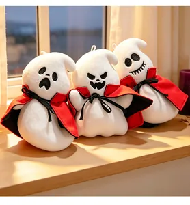 Three cute Halloween ghost plush toys wearing red capes on a sunny wooden windowsill