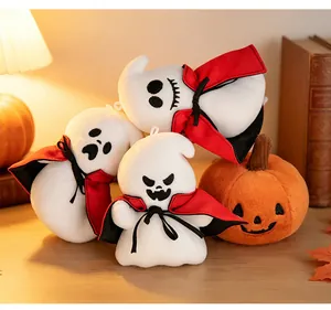 Detailed view of soft Halloween plush ghost dolls wearing red capes with a pumpkin