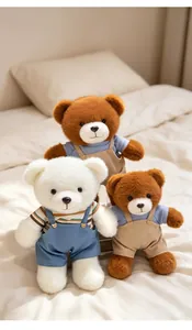 Three cute teddy bears in overalls sitting on a cozy bed for home decoration.