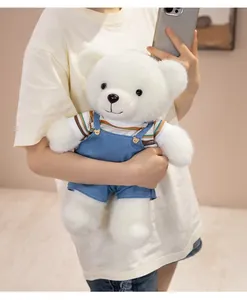 Adorable white teddy bear plush toy wearing cute denim overalls and striped t-shirt