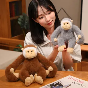Adorable long-armed gibbon plush monkey dolls in brown and grey shown in a home setting