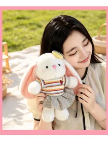 Soft white plush rabbit toy with long pink ears in a striped shirt and plaid skirt