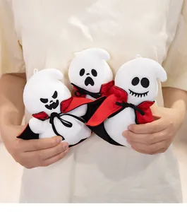 Detailed view of three funny Halloween ghost plush toys with red capes held in hands