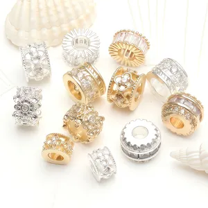 Detailed view of various gold and silver micro-pave zircon beads for DIY jewelry making.