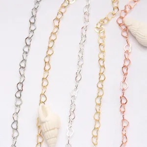Détail de maillons de chaîne en forme de cœur remplis d'or 14K en or argent et rose