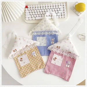 Detailed shot of cute house-shaped hanging fabric tissue bag covers in plaid patterns