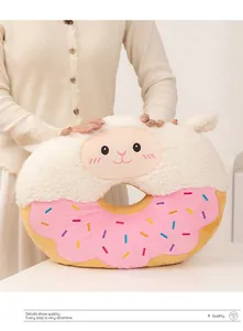 Detail view of a cute cartoon doughnut plush cushion with soft alpaca embroidery